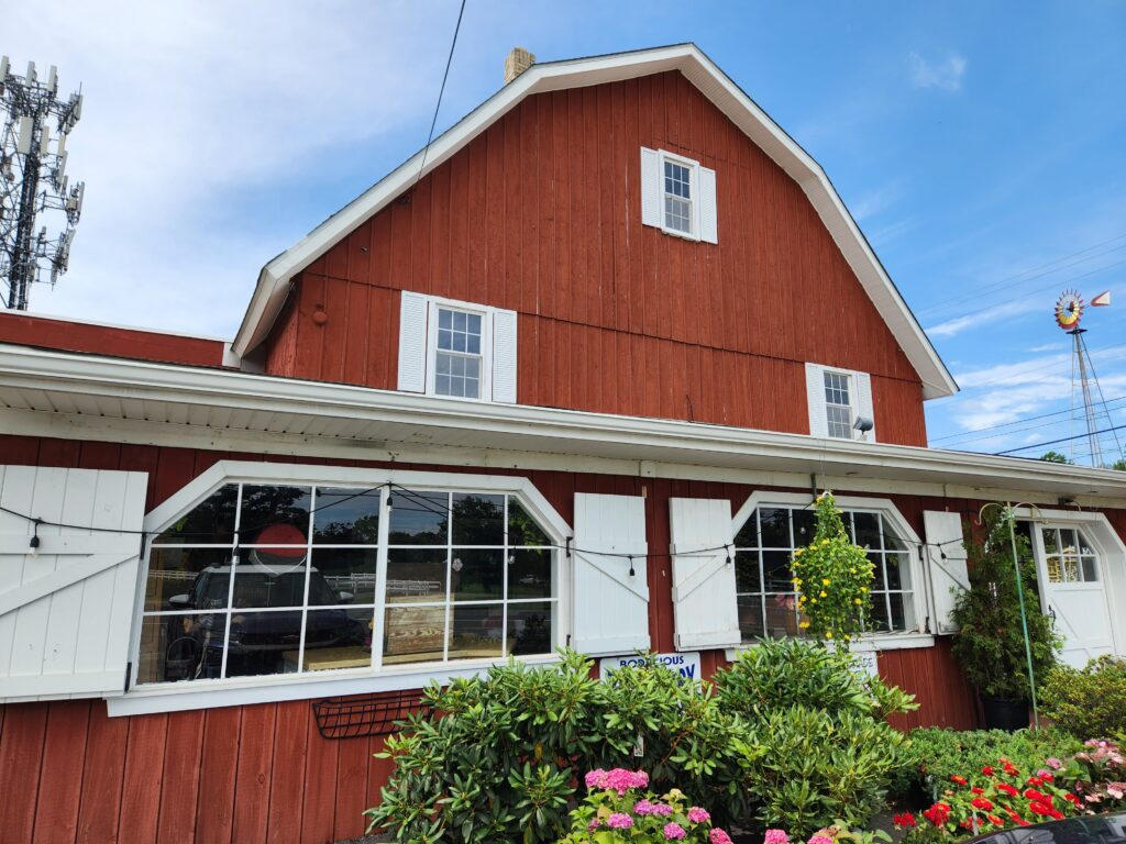 White shutters and flower beds on the Red Barn cafe