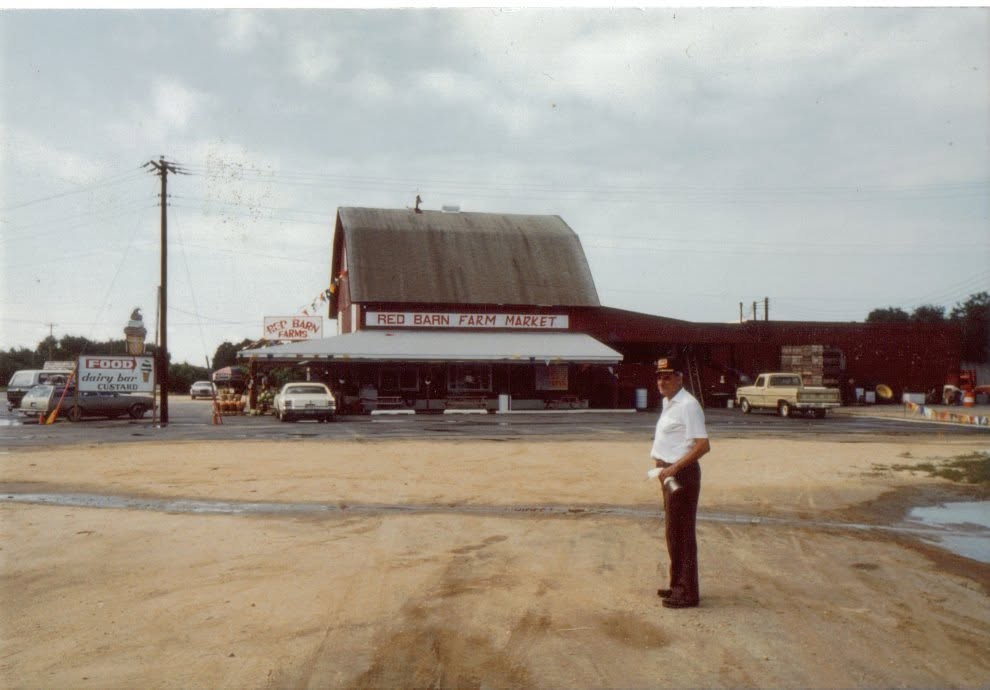 The Red Barn Farm Market in the 1980s, with the original sign and sandy lot