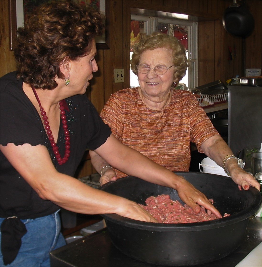 Evelyn and family mixing sauce in the barn kitchen